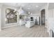 Bright, open kitchen with white cabinets, stainless steel appliances, and large windows for ample natural light at 786 E Coconino Dr, Chandler, AZ 85249
