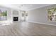 Bright living room boasts fireplace, multiple windows, crown moulding, and light wood flooring at 786 E Coconino Dr, Chandler, AZ 85249