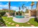 Inviting backyard pool featuring artificial grass, stone accents, and lush palm trees at 786 E Coconino Dr, Chandler, AZ 85249