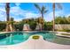Backyard pool surrounded by lush landscaping and swaying palm trees at 786 E Coconino Dr, Chandler, AZ 85249