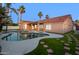 Inviting backyard pool surrounded by lush green grass and stepping stones, perfect for outdoor relaxation at 786 E Coconino Dr, Chandler, AZ 85249