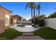 Backyard pool oasis with lush artificial grass, surrounded by a concrete patio and elegant landscaping at 786 E Coconino Dr, Chandler, AZ 85249