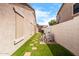 Long side yard features artificial turf, hardscape pavers, and wall at 786 E Coconino Dr, Chandler, AZ 85249
