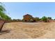 Backyard view showcasing the home's exterior and the brick patio at 833 S 113Th Ave, Avondale, AZ 85323