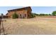 Large backyard featuring a two-story home and a patio surrounded by trees at 833 S 113Th Ave, Avondale, AZ 85323