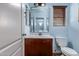 Cozy bathroom with updated vanity, commode, medicine cabinet, and fixtures in a house for sale at 833 S 113Th Ave, Avondale, AZ 85323