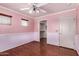 Bedroom showcasing a window, a ceiling fan, a walk-in closet, and stylish flooring at 833 S 113Th Ave, Avondale, AZ 85323