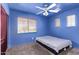 Cozy bedroom showcasing a window, a ceiling fan, and carpet flooring at 833 S 113Th Ave, Avondale, AZ 85323