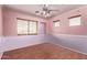 Bedroom with stylish flooring, large window, ceiling fan, and two-tone walls at 833 S 113Th Ave, Avondale, AZ 85323