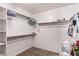 Walk-in closet featuring built-in shelving and ample storage space for organization at 833 S 113Th Ave, Avondale, AZ 85323