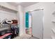 Open walk-in closet with hanging rods and shelving next to a sliding door at 833 S 113Th Ave, Avondale, AZ 85323
