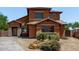Inviting two-story home with a beautiful terracotta exterior and lovely desert landscaping at 833 S 113Th Ave, Avondale, AZ 85323
