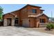 Stunning two-story house featuring a terracotta exterior, a garage, and stone accents at 833 S 113Th Ave, Avondale, AZ 85323