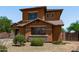 Beautiful two-story house showcasing desert landscaping, stone accents, and a terracotta exterior at 833 S 113Th Ave, Avondale, AZ 85323