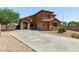 Gorgeous two-story house boasting a xeriscaped front yard, a concrete driveway, and terracotta exterior at 833 S 113Th Ave, Avondale, AZ 85323