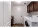 Laundry room with washer, dryer and storage cabinets at 833 S 113Th Ave, Avondale, AZ 85323