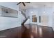 Expansive living room with high ceilings, hardwood floors, and iron railing staircase at 833 S 113Th Ave, Avondale, AZ 85323