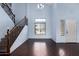 Large living room with hardwood floors, an iron railing staircase, and plenty of natural light at 833 S 113Th Ave, Avondale, AZ 85323