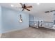 Spacious loft area featuring carpeting, wrought iron railing, and natural light at 833 S 113Th Ave, Avondale, AZ 85323