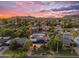 Aerial view of home with well-maintained landscaping and solar panels, set against a mountain backdrop at 908 E State Ave, Phoenix, AZ 85020