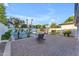 A beautiful backyard featuring a pool, patio with lounge chair, a grilling area, and privacy landscaping at 908 E State Ave, Phoenix, AZ 85020