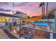 Spacious backyard features an outdoor kitchen, pool, seating area and beautiful landscaping at 908 E State Ave, Phoenix, AZ 85020
