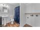 Cozy bathroom features a vanity sink, toilet, blue shower curtain, and laundry hookups at 908 E State Ave, Phoenix, AZ 85020