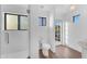 Well-lit bathroom featuring white tiling, modern toilet, and a glass door shower with ample natural light at 908 E State Ave, Phoenix, AZ 85020