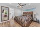 Bedroom with ceiling fan, large mirror, and an attached bath at 908 E State Ave, Phoenix, AZ 85020