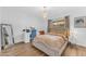 Bright bedroom features a chandelier, sleek desk, and a large mirror at 908 E State Ave, Phoenix, AZ 85020