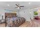 Bedroom featuring a ceiling fan, large window, and ensuite access at 908 E State Ave, Phoenix, AZ 85020