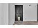 Stylish black front door with decorative mat and brick pathway leading into a bright, modern home at 908 E State Ave, Phoenix, AZ 85020