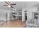 Open kitchen with stainless steel appliances, gray cabinets, and wood flooring, creating a modern, inviting space at 908 E State Ave, Phoenix, AZ 85020