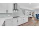 Bright kitchen featuring white cabinets, stainless steel appliances, and tile backsplash at 908 E State Ave, Phoenix, AZ 85020