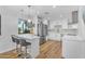 Modern kitchen with a center island, stainless steel appliances, white cabinets, and wood floors at 908 E State Ave, Phoenix, AZ 85020