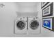 Well-lit laundry room featuring modern Samsung washer and dryer units and decorative wall art at 908 E State Ave, Phoenix, AZ 85020