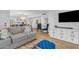Open-concept living room featuring hardwood floors, comfortable seating, and modern decor at 908 E State Ave, Phoenix, AZ 85020