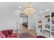 Living room with chandelier, bookshelves and view to another room at 908 E State Ave, Phoenix, AZ 85020