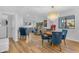 Bright open-concept living room with a chandelier, stylish blue chairs, and hardwood flooring at 908 E State Ave, Phoenix, AZ 85020