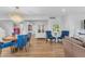 Bright open-concept living room with a chandelier, stylish blue chairs, and hardwood flooring at 908 E State Ave, Phoenix, AZ 85020