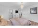 Bright bedroom featuring hardwood floors, a modern dresser, and a full en-suite bathroom at 908 E State Ave, Phoenix, AZ 85020