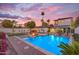 Stunning pool with fountains, surrounded by lush landscaping, set against a picturesque twilight sky at 908 E State Ave, Phoenix, AZ 85020