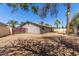 View of the home's spacious backyard with block fencing and lovely palm trees at 10115 W Turney Ave, Phoenix, AZ 85037