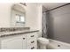 Bathroom featuring a shower, toilet, sink with granite countertop, and white cabinet at 10115 W Turney Ave, Phoenix, AZ 85037