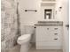 Bathroom featuring a granite countertop vanity, toilet, and stylish shower curtain at 10115 W Turney Ave, Phoenix, AZ 85037
