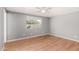 A cozy bedroom featuring hardwood floors and a view of the outdoor space at 10115 W Turney Ave, Phoenix, AZ 85037