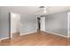 Spacious bedroom featuring a ceiling fan, closet, and lovely hardwood floors at 10115 W Turney Ave, Phoenix, AZ 85037