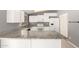 A modern kitchen featuring white cabinets, granite countertops and stainless steel appliances at 10115 W Turney Ave, Phoenix, AZ 85037