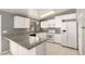A spacious kitchen featuring white cabinets, granite countertops and stainless steel appliances at 10115 W Turney Ave, Phoenix, AZ 85037