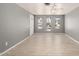 An open living room offers tile floors and light grey walls and natural light at 10115 W Turney Ave, Phoenix, AZ 85037